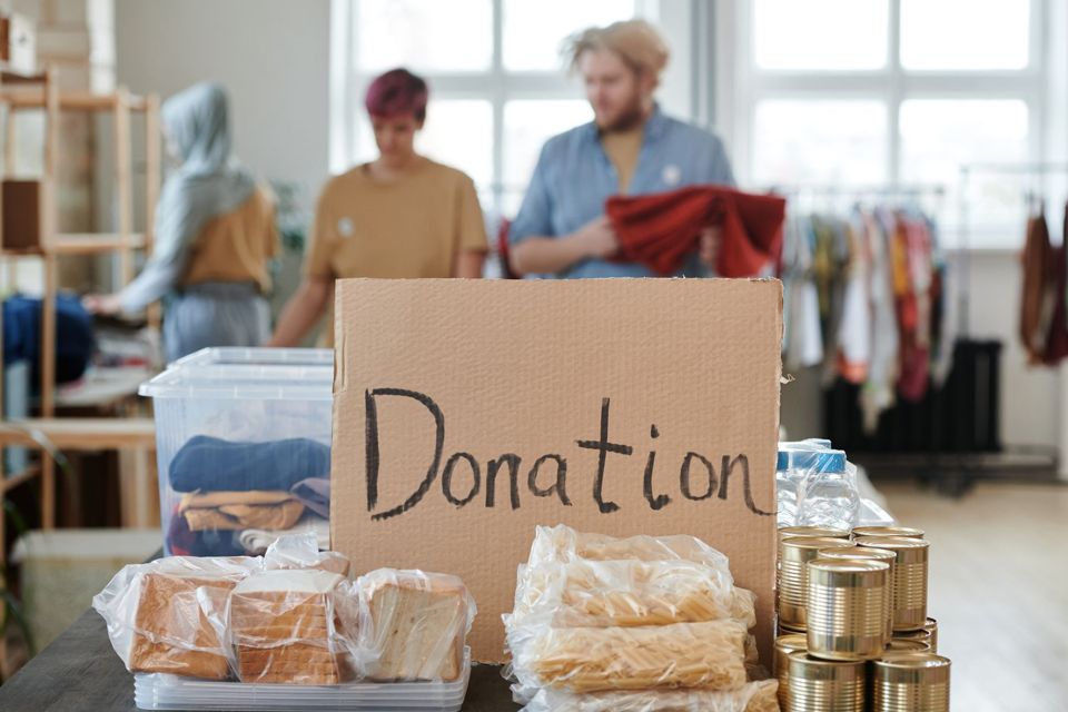 A nonprofit team organizing food and clothing donations for neighbors in need