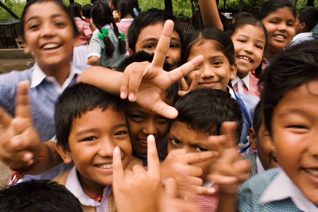 Children and community leaders sharing a joyful moment together