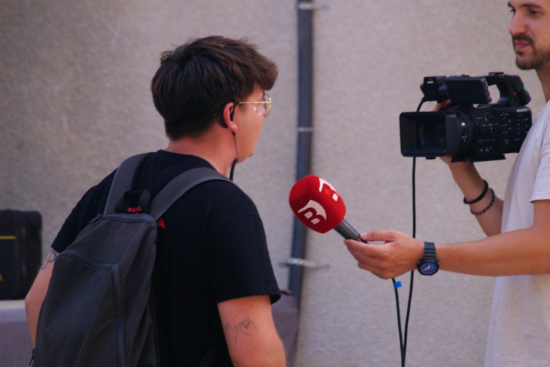 A reporter interviewing a spokesperson during a live media event