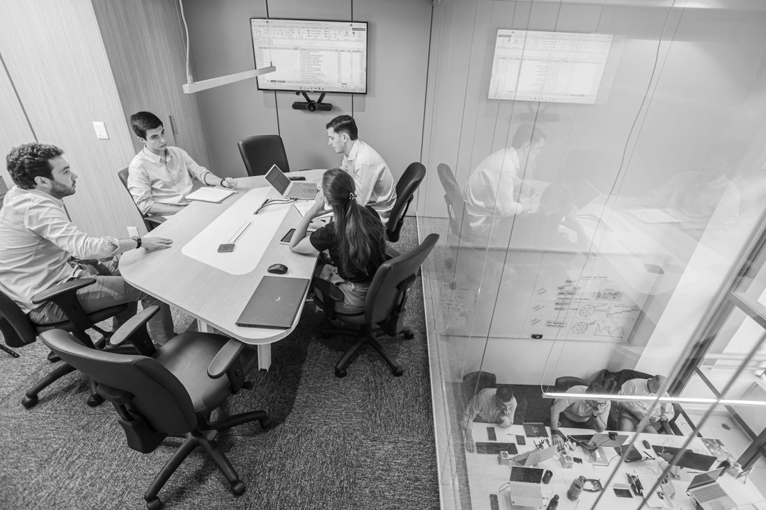 Leaders gathered around a table for a collaborative strategy session